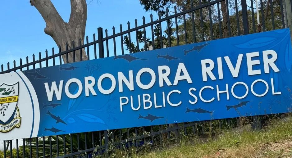 Woronora River Public School sign on the school's chainwire fence